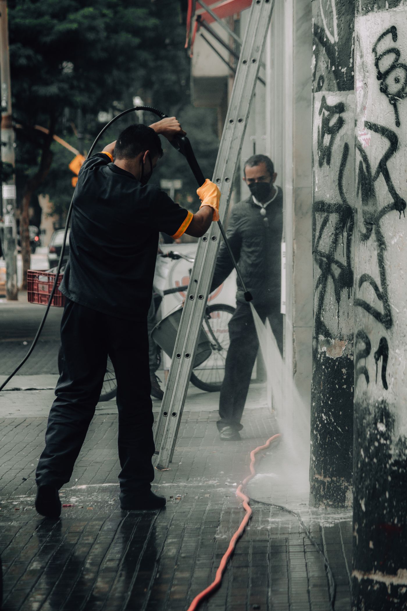Storefront sidewalk being pressure washed