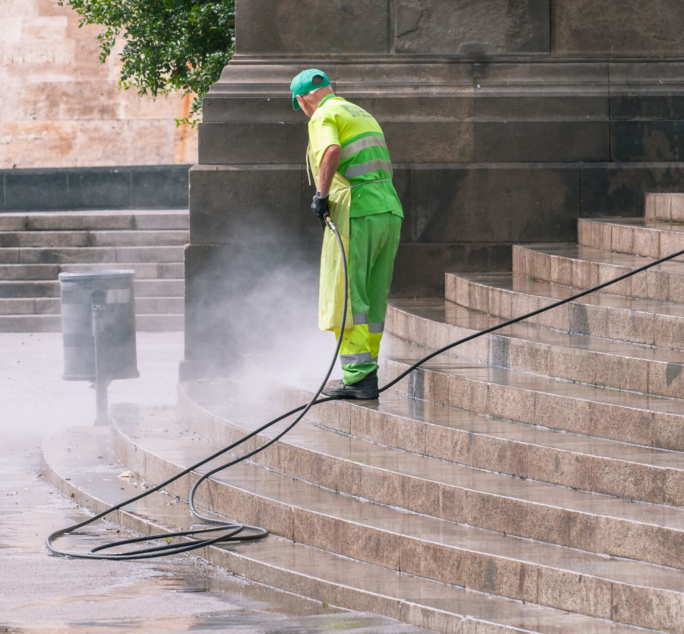Crew pressure washing stone steps