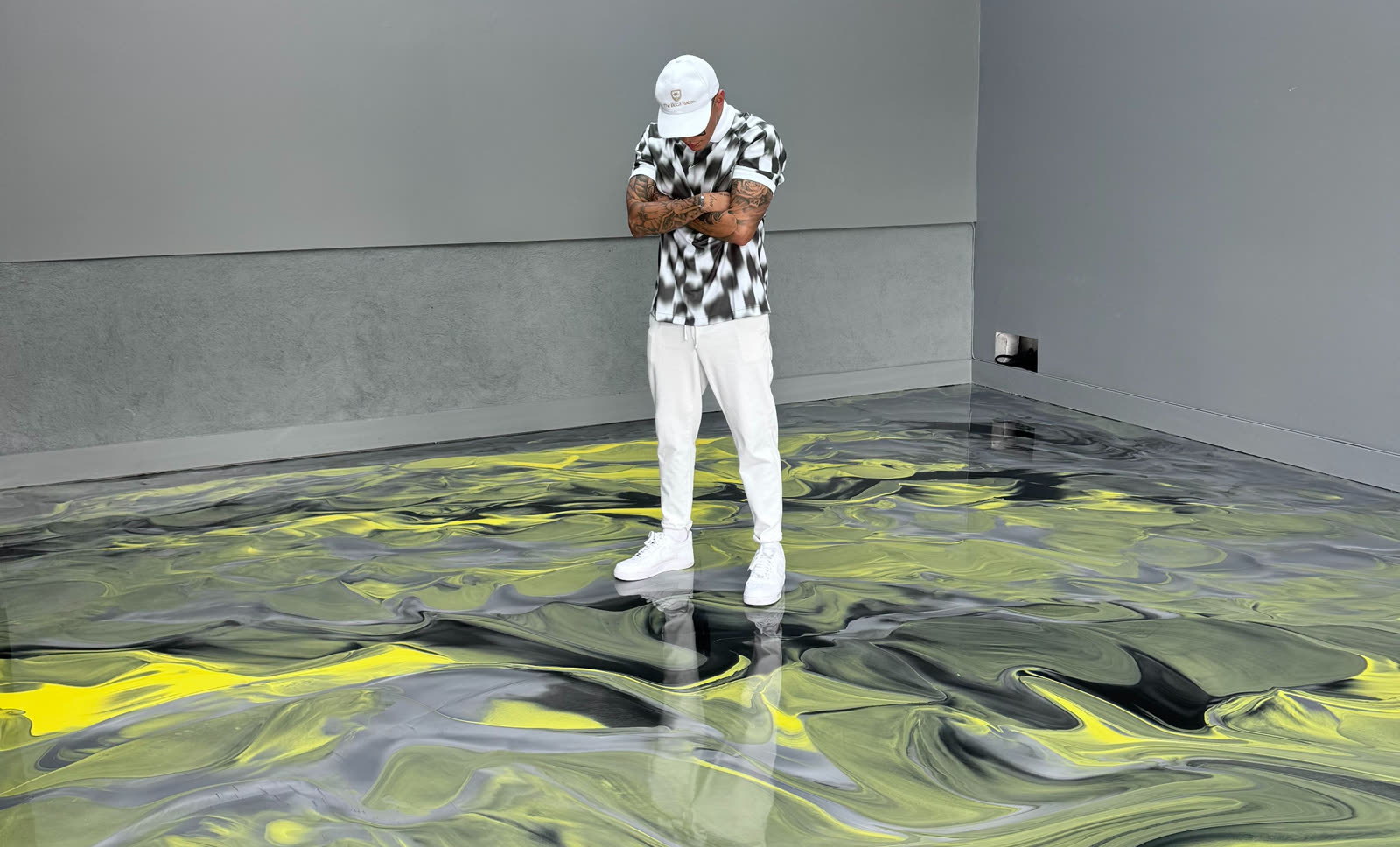 Don standing on a finished yellow and charcoal metallic resin floor
