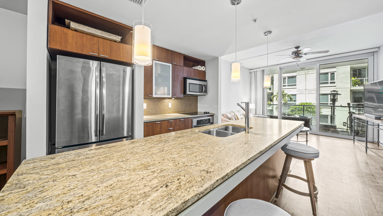 Kitchen photograph with granite island and stainless appliances in a Tampa condo