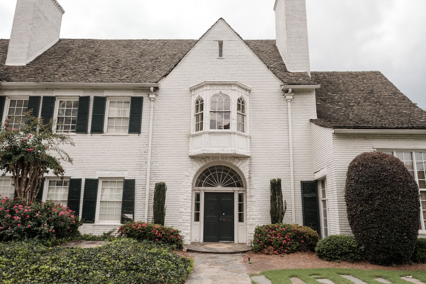 White painted brick estate home with slate roof