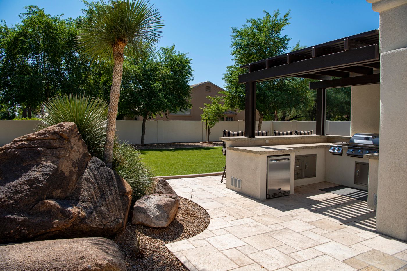 Travertine patio with outdoor kitchen after cleaning