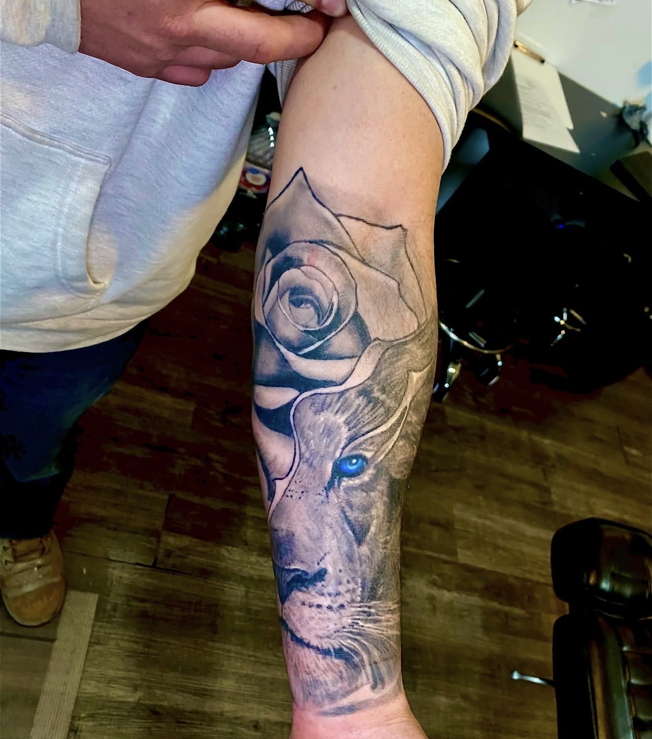 Healed view of the rose and lion forearm tattoo in natural light
