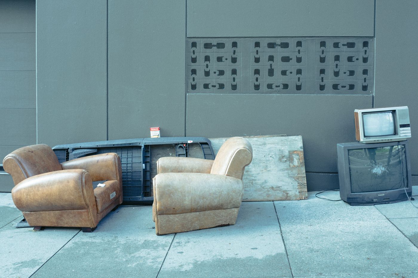 Old furniture and a broken television set out for pickup